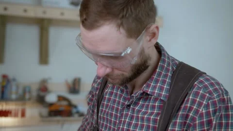 Worker at carpenter workspace cutting the edge of wood board using fret saw Stock Footage 151274279