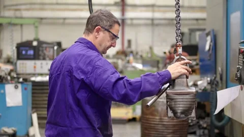 Worker carrying and preparing tools to work in a factory Stock Footage 259241074