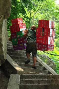 Worker is carrying boxes with beverages Stock Photos