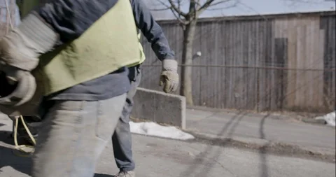 Worker carrying drill auger towards the truck Stock Footage 145282592