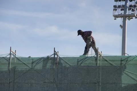Worker carrying drill Foto stock