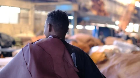 Worker Carrying Leather On Its Shoulder At A Factory In Ethiopia. - back view Stock Footage 313189131