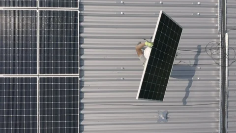 Worker Carrying Solar Panel On Rooftop D-Log Stock Footage 117848986