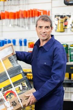 Worker Carrying Tool Package In Hardware Shop Stock Photos