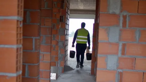 Worker Carrying Two Buckets Up Stairs to First Floor, Unfinished Grey Floor Vídeos de archivo 299266776