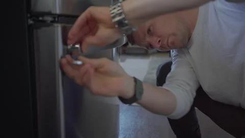 Worker change handle of fridge in kitchen. Stock Footage 250442792