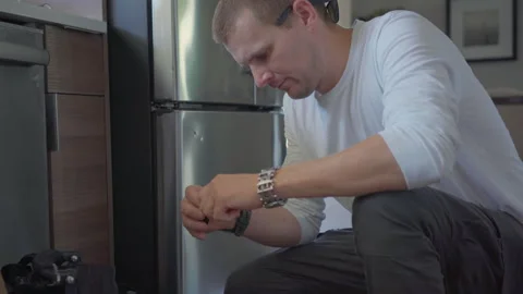 Worker change handle of fridge in kitchen. Stock Footage 250444440