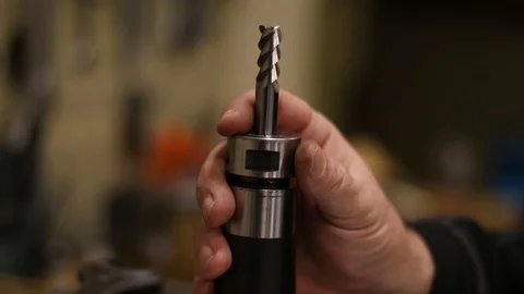 The worker changes the cutter. Metalworking production.CNC rigging Stock Footage 124770852