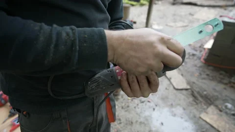Worker changes grinding wheel on an angle grinder Stock Footage 158972391