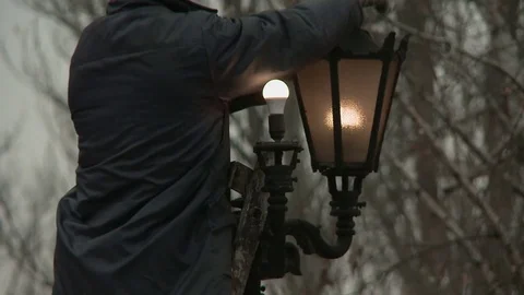 Worker changes the lamp on the lamp post Stock-Footage 73700145