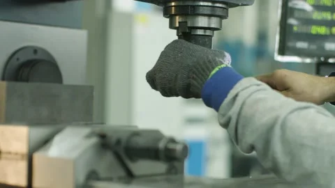 A worker changing the carbide head on a milling cutter Stock Footage 172189050
