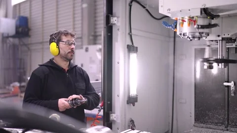 Worker changing the lathe of a milling machine Stock Footage 259435195