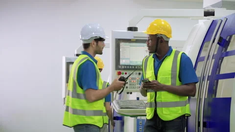 Worker in charge of the machine control panel playing on the phone 스톡 동영상 140212654