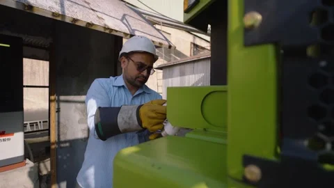 Worker charging an NHL TR50E EV Mining Dump Truck. Pakistan. Right reveal pan 스톡 동영상 332518963