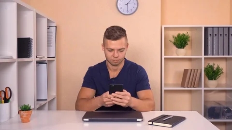 Worker chatting on cellular in office Stock Footage 87539902