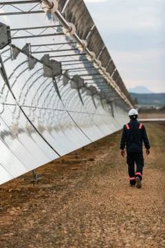 Worker checking the concentrators and solar panels of the solar thermal power Stock Photos