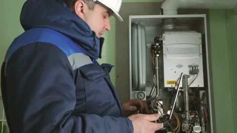 Worker checking gas-fire boiler Stock Footage 87762163