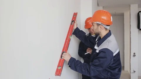 Worker checking level of wall at construction site Stock Footage 73441967