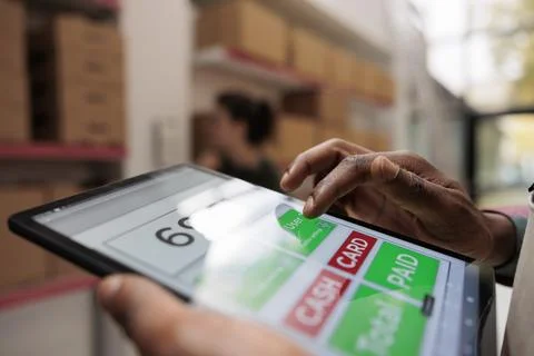 Worker checking online customers orders using tablet Foto stock