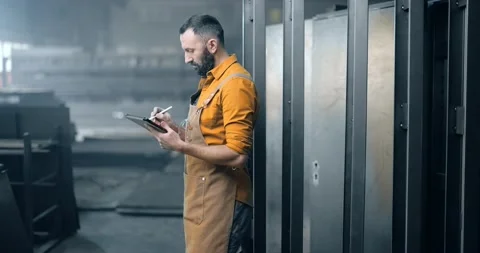 Worker checking the quality of metal products with a digital tablet Stock Footage 147287834