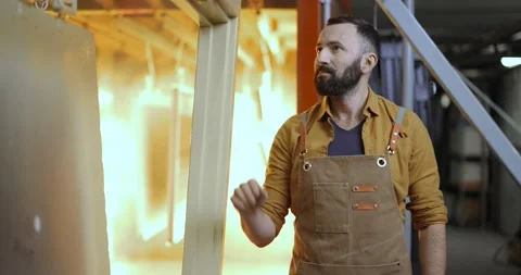 Worker checking the quality of the painted with powder coating metal products Stock Footage 147276190