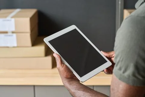 Worker checking track numbers on tablet pc Fotos Stock