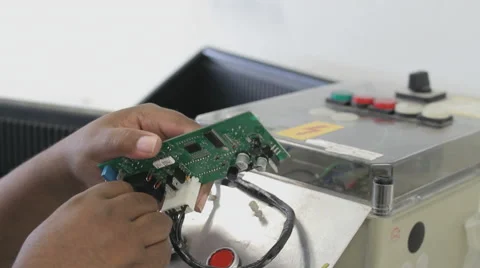 A worker checks circuit boards - Surface Mount Technology (Smt) Stock Footage 54198664