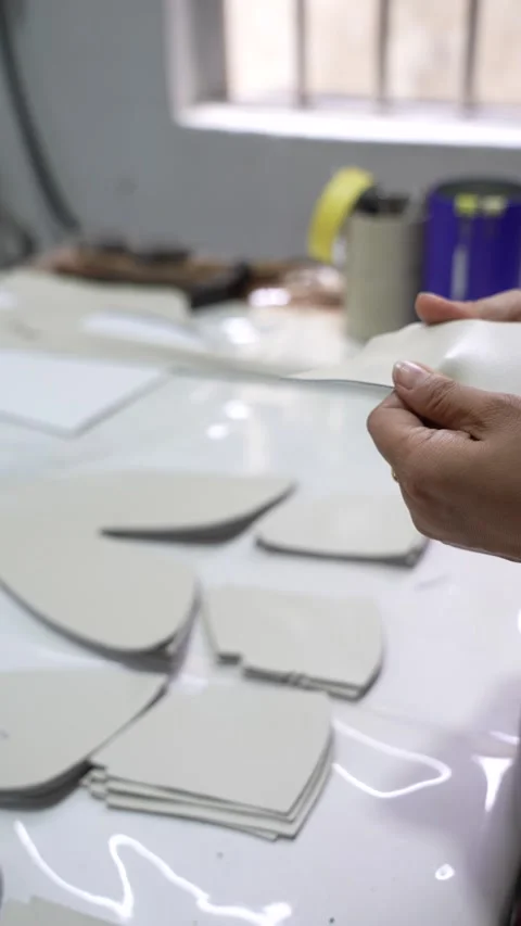 Worker Checks Cut Component Edges at Factory Table Vertical Stock Footage 340182743
