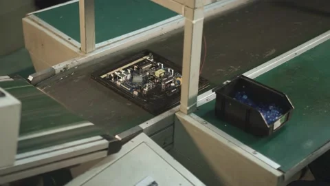 Worker checks an electronic board after soldering at a TV factory 스톡 동영상 162365321