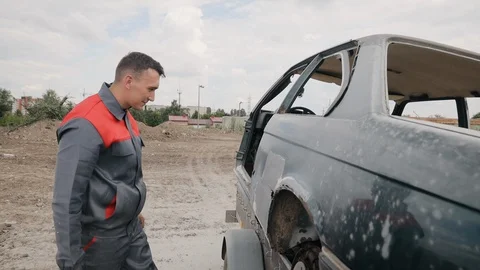 The worker checks his job on a repaired car after rust removing Stock Footage 128263266