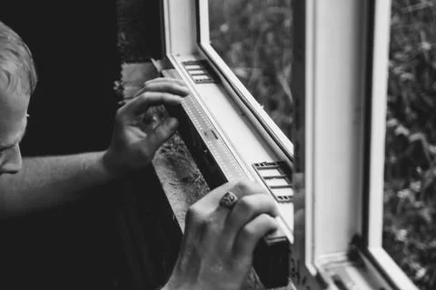 Worker checks the level of a window Stock Photos