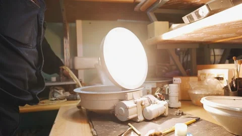 A worker checks the operation of an electric lamp that stands on the table Stock Footage 155211422