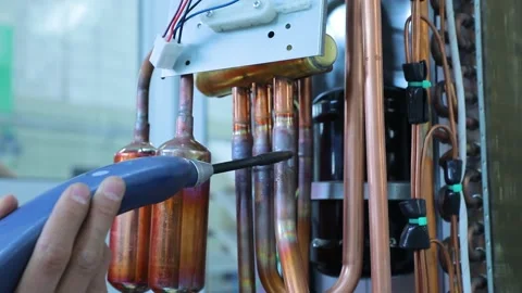 Worker checks the quality of welding for leakage of freon in the air conditioner Video stock 162910499