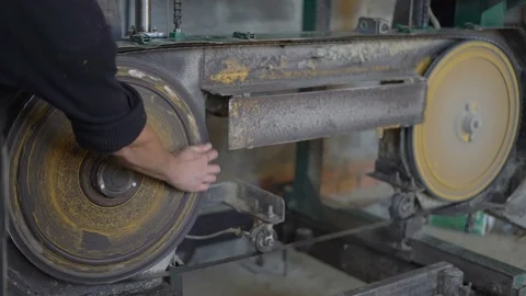 A Worker Checks The Stretch Hole Saw by Cranking the Shaft of the Sawmill Stock Footage 76641066