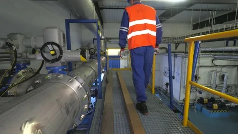The worker checks the valves behind the compressors of the high-pressure biogas  Stock Footage 140941289