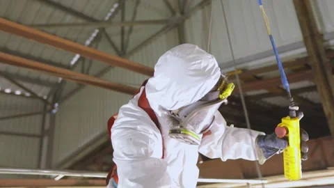 Worker in chemical protection. A worker in a protective suit at a cleaning Stock Footage 170578024