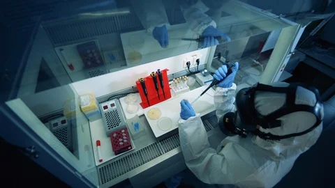 Worker in chemical suit develops a vaccine against covid-19. Coronavirus, covid 스톡 동영상 127605035