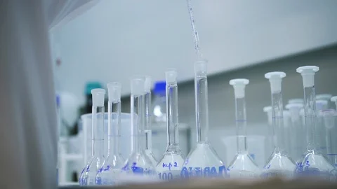 Worker chemist dripping liquid into test tube flask Spbd. Closeup. Liquid Stock Footage 129524756