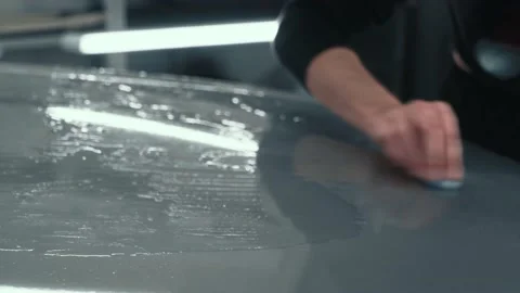 Worker clean car body with blue clay for cleaning before installing protective Stock Footage 150402776