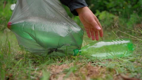Worker cleaner remove garbage rubbish in bag at forest meadow Stock Footage 158122629