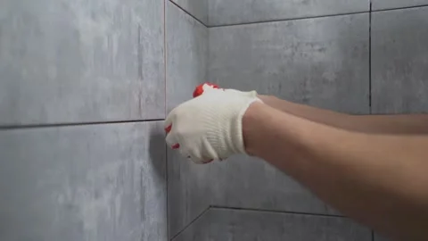 Worker Cleaning and Grouting Tile Seams Stock Footage 333397342