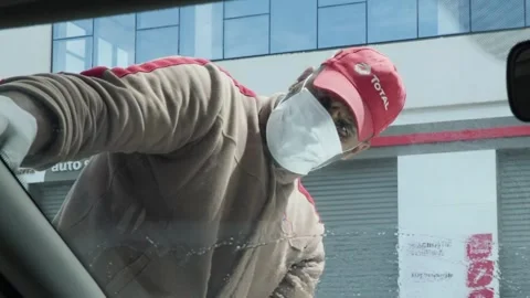 Worker Cleaning Car Windshield Wearing Face Mask in Morocco Stock Footage 328542647