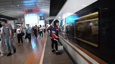 A worker cleaning a China high-speed train at Beijing South Railway Station Stock Footage 94511355