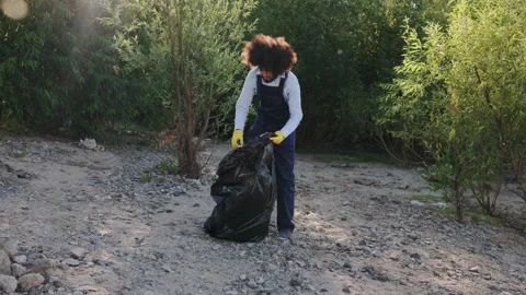 Worker Cleaning up Dirty beach from Plastic and Collect Waste in Trash Black Stock Footage 148148393