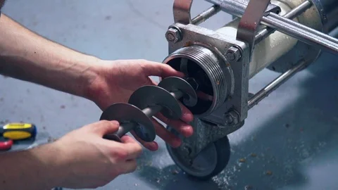Worker cleaning distillery mash machine during maintenance Stock Footage 86709723
