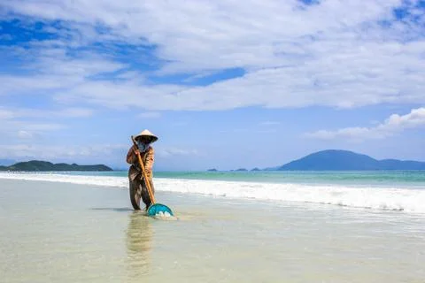 Worker Cleaning Doc Let Beach, Vietnam Stock Photos