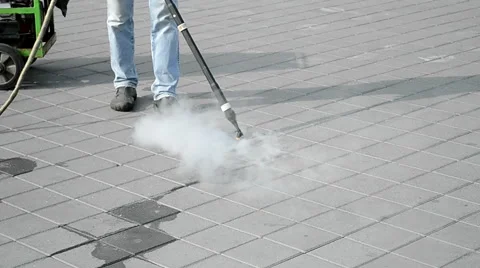Worker cleaning floor with hot steam device, long metal hose, environment. Video stock 47171014