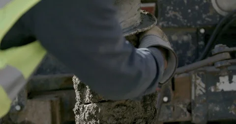 Worker cleaning mud from the drill auger Stock Footage 145282720