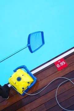 Worker cleaning the pool. Automatic pool cleaners. Stock Photos