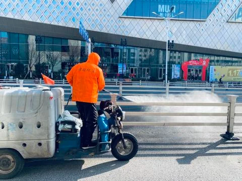 A worker cleaning with pressure machine Stock Photos